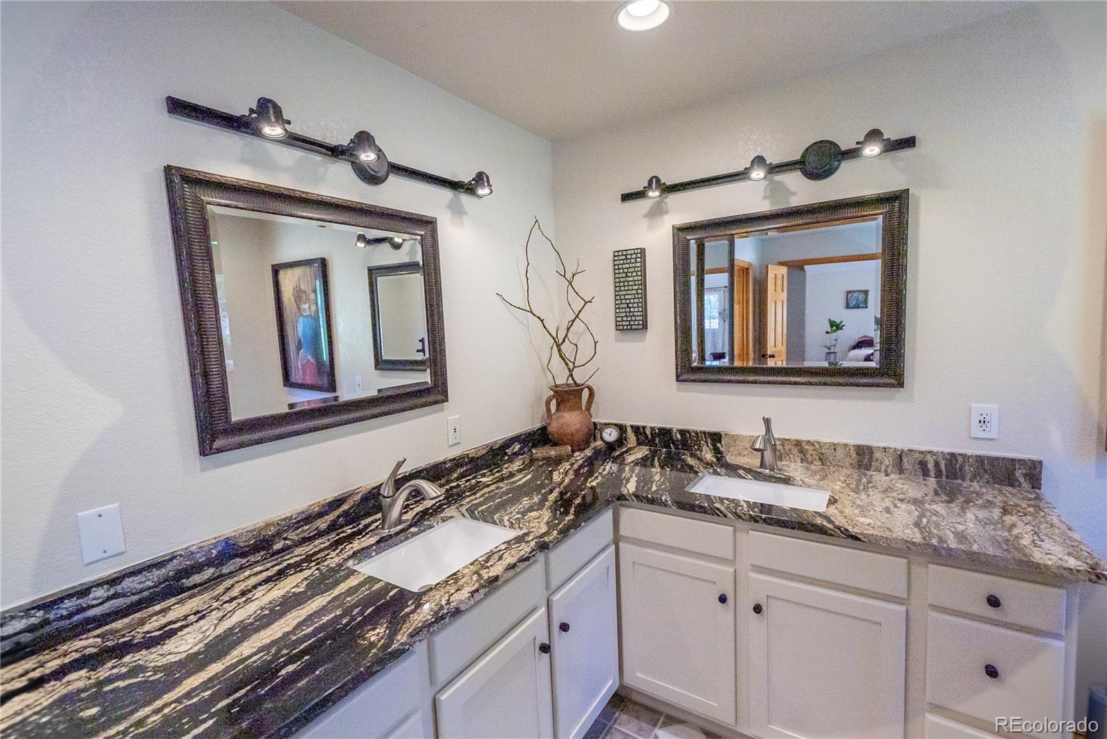 417 Witter Gulch Road Evergreen, CO 80439 - Photo 16 of 39 a bathroom with a sink and a mirror