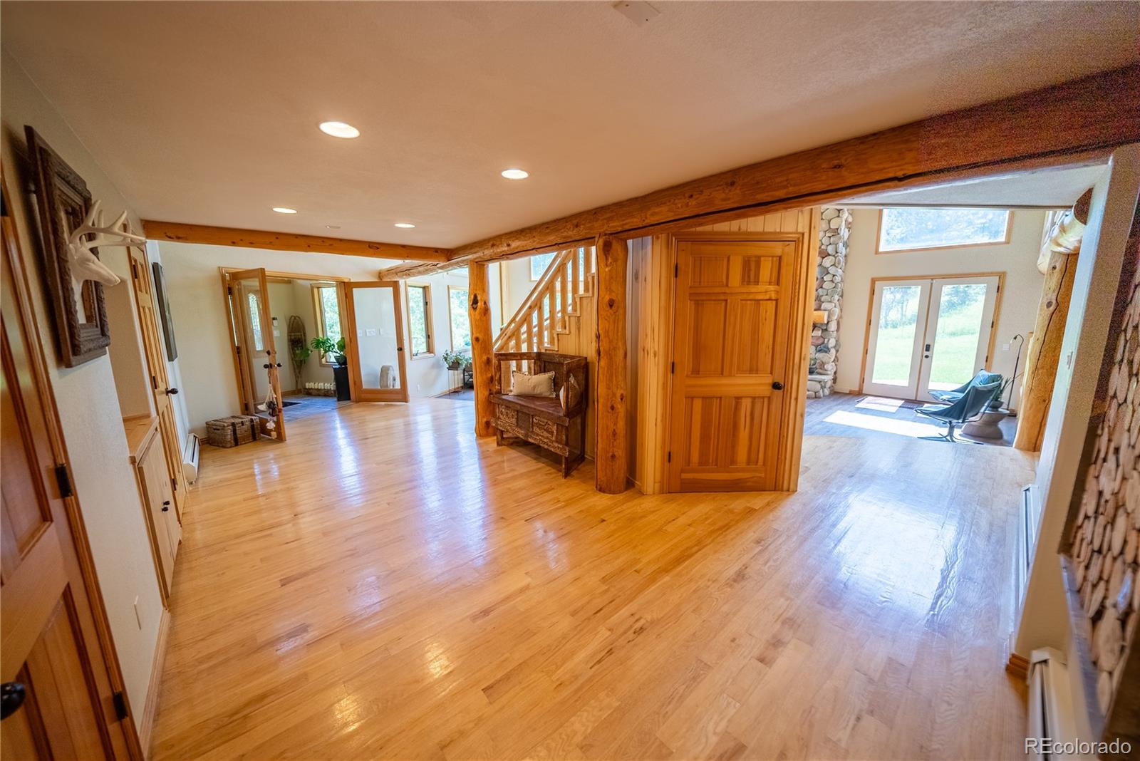 417 Witter Gulch Road Evergreen, CO 80439 - Photo 22 of 39 a view of a big room with wooden floor and windows