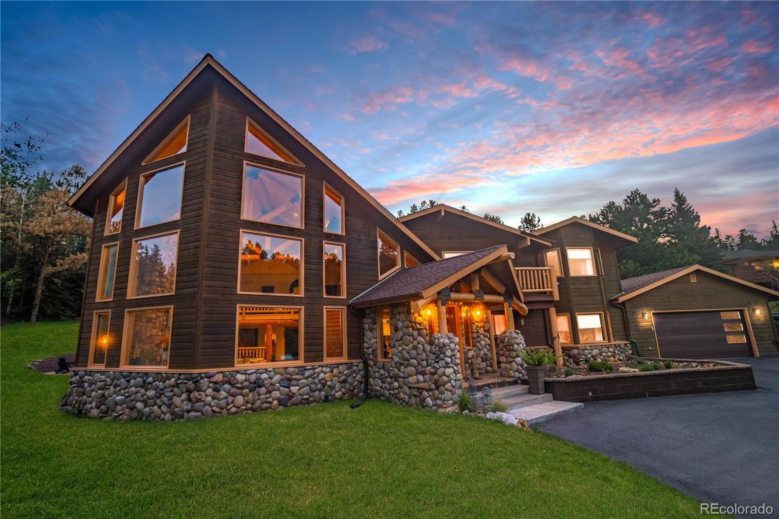 417 Witter Gulch Road Evergreen, CO 80439 - Photo 30 of 39 a view of a house with a yard