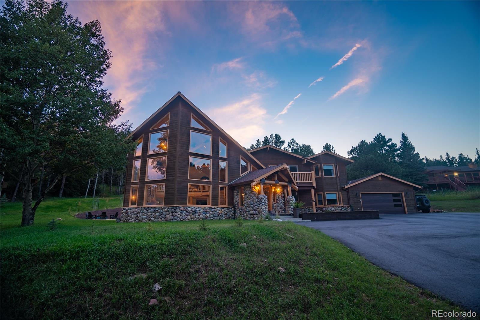 417 Witter Gulch Road Evergreen, CO 80439 - Photo 31 of 39 a front view of a house with garden