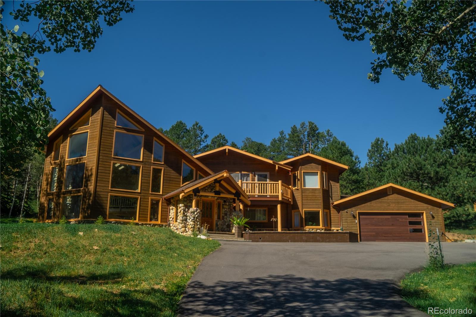 417 Witter Gulch Road Evergreen, CO 80439 - Photo 32 of 39 a front view of a house with a yard
