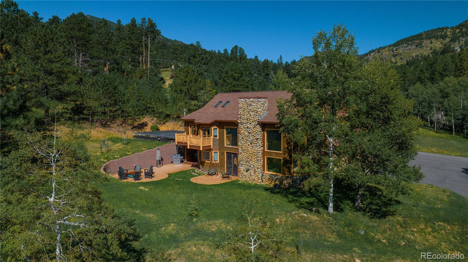 417 Witter Gulch Road Evergreen, CO 80439 - Photo 35 of 39 an aerial view of a house with garden space and trees all around
