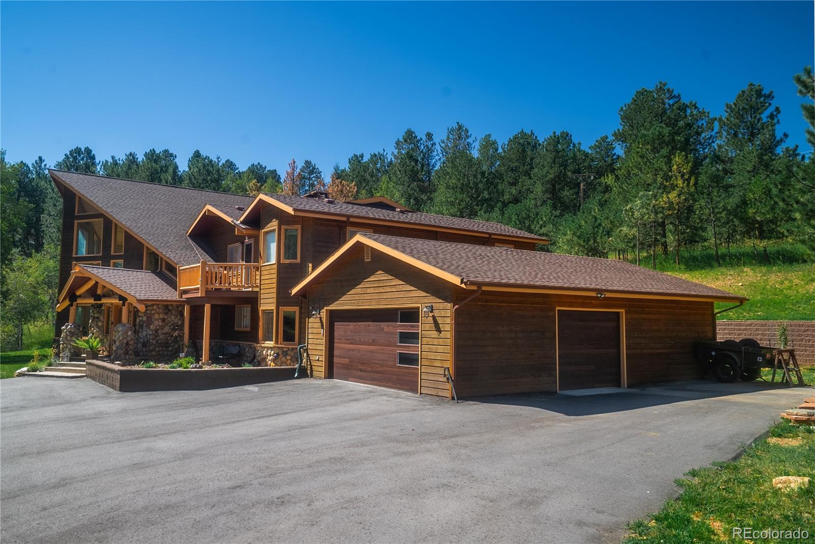 417 Witter Gulch Road Evergreen, CO 80439 - Photo 36 of 39 a front view of a house with a yard