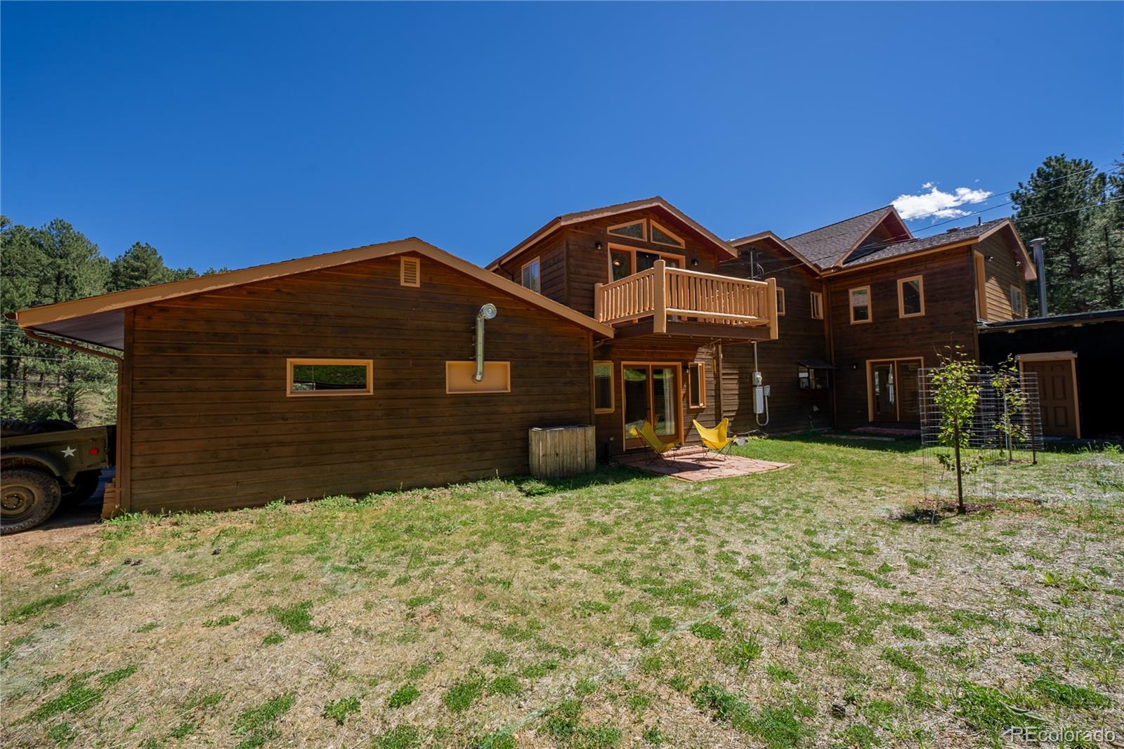 417 Witter Gulch Road Evergreen, CO 80439 - Photo 37 of 39 a view of a house with a yard