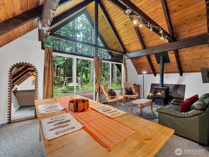 a living room with furniture a rug and a large window