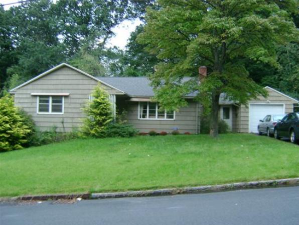 143 East Allen Ridge Road Springfield, MA 01118 - Photo 1 of 18 a front view of a house with a garden