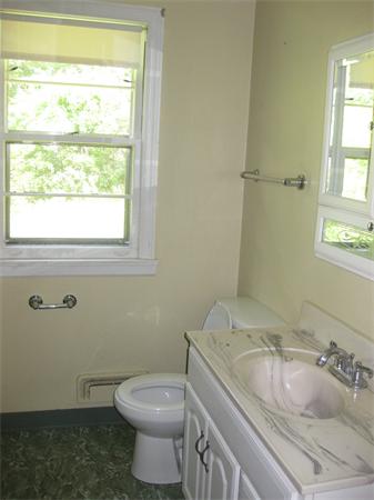 143 East Allen Ridge Road Springfield, MA 01118 - Photo 6 of 18 a bathroom with a granite countertop toilet a sink and a window