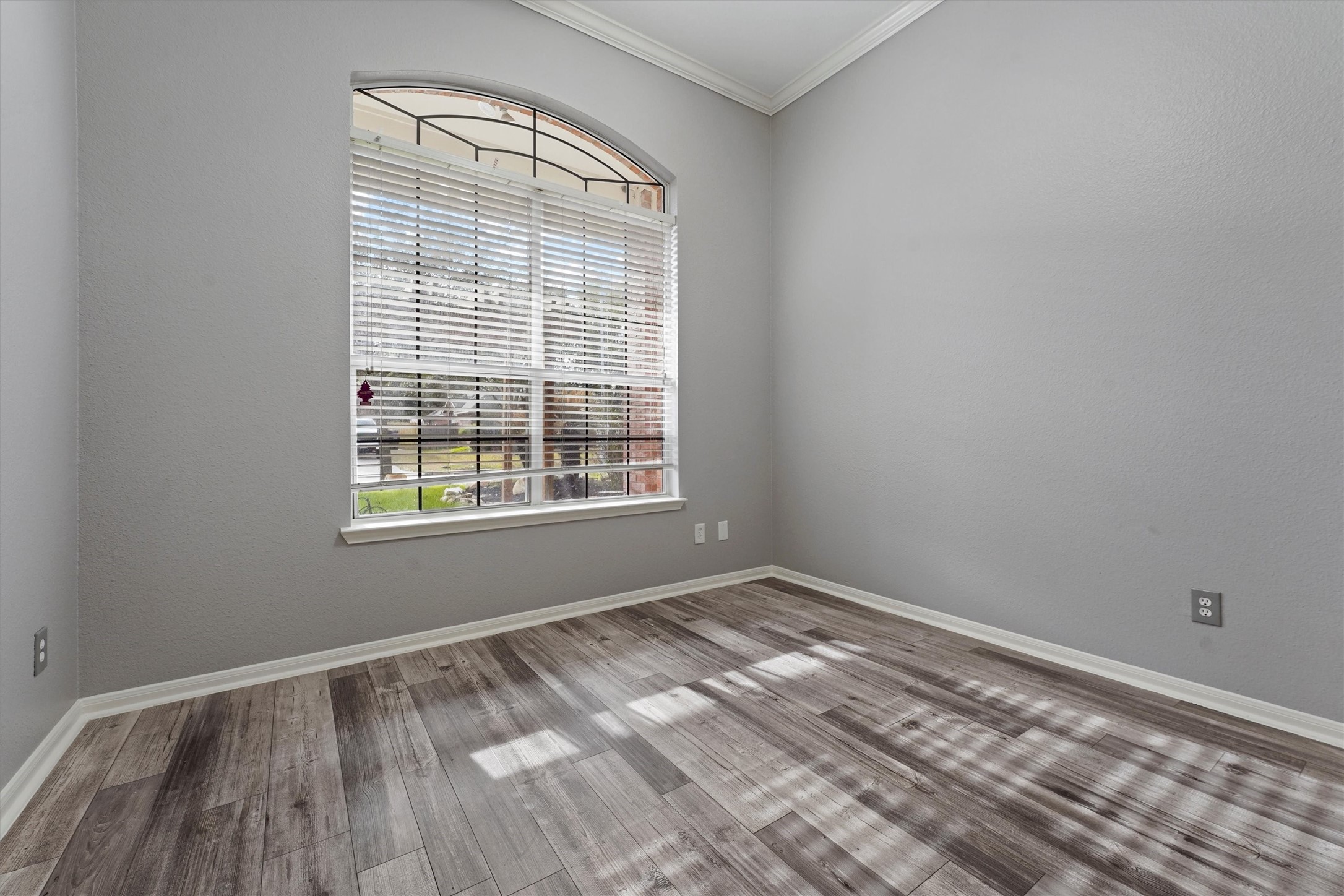 24522 Forest Path Court Spring, TX 77373 - Photo 2 of 18 a view of an empty room with wooden floor and a window