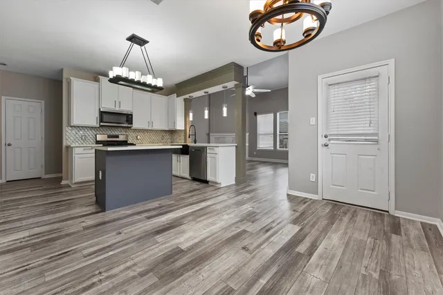 a view of a kitchen with stove and cabinets