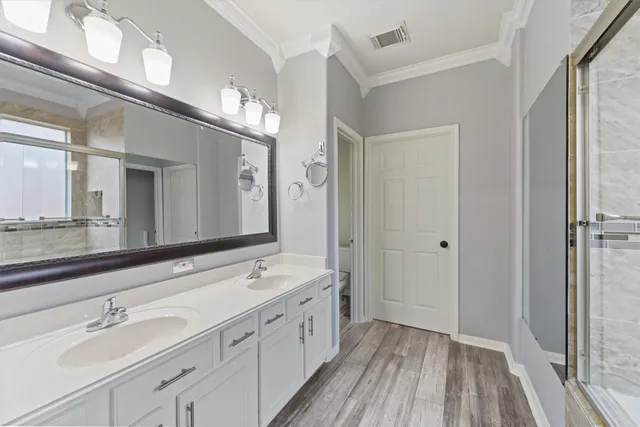a spacious bathroom with a double vanity sink and a mirror