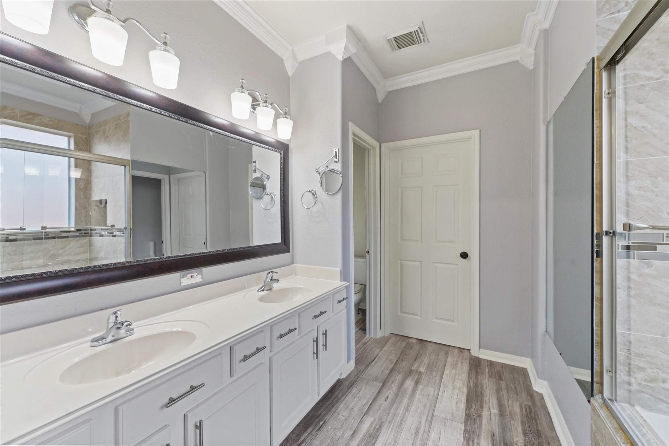 24522 Forest Path Court Spring, TX 77373 - Photo 7 of 18 a spacious bathroom with a double vanity sink and a mirror