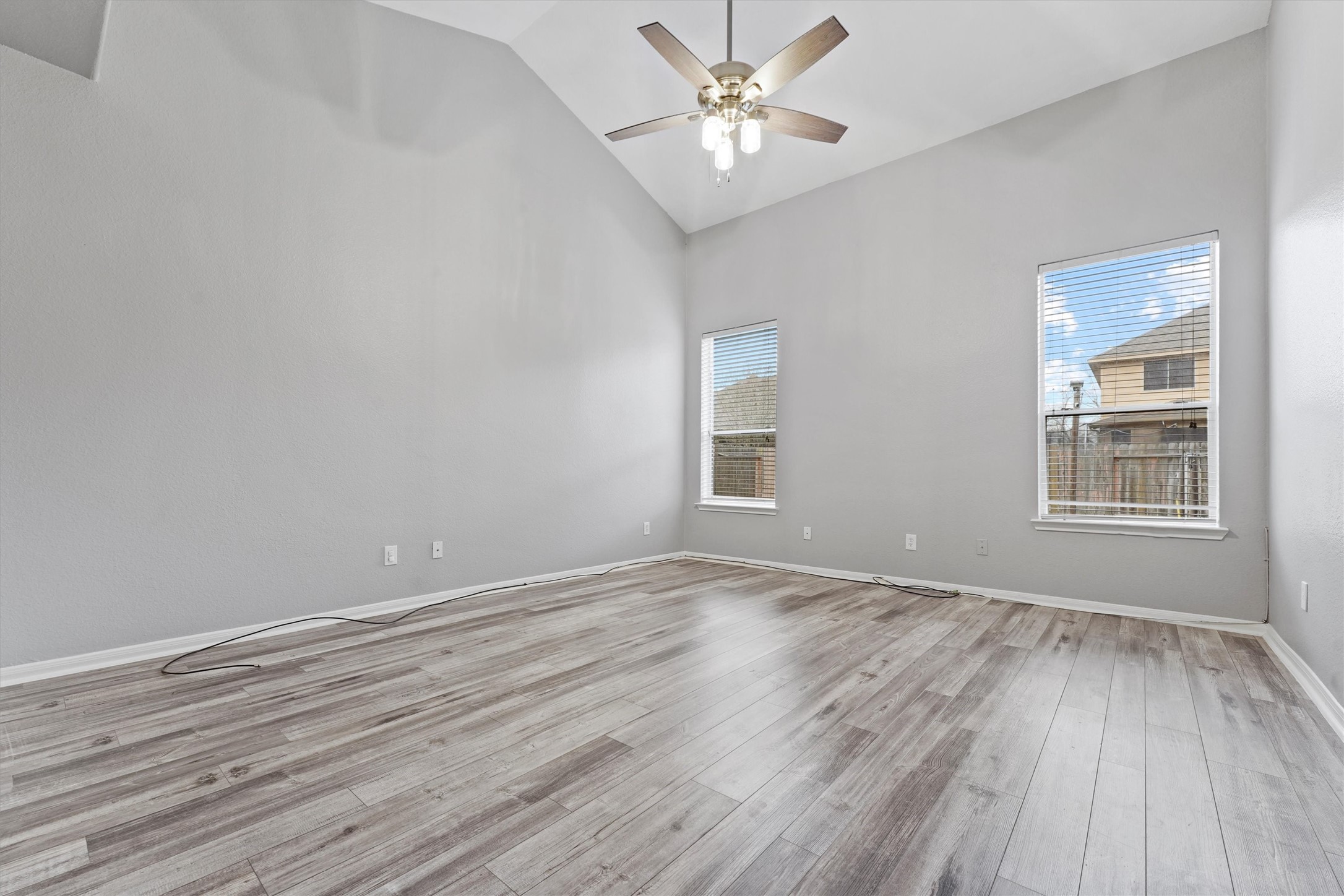 24522 Forest Path Court Spring, TX 77373 - Photo 10 of 18 a view of an empty room with wooden floor and a window