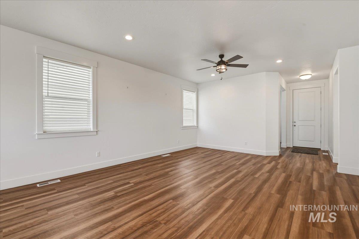2109 North Gelding Court Middleton, ID 83644 - Photo 11 of 39 Spare room featuring dark wood-style floors, ceiling fan, and recessed lighting