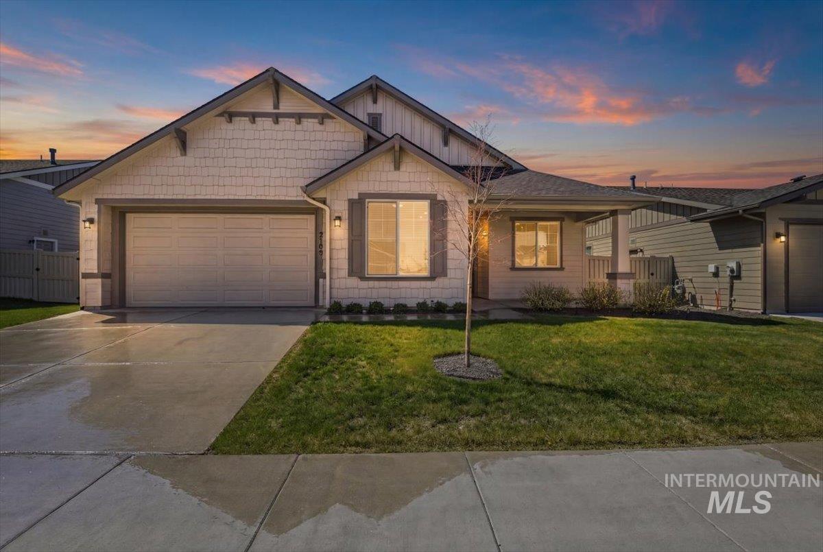 2109 North Gelding Court Middleton, ID 83644 - Photo 2 of 39 View of front facade with an attached garage, a front yard, covered porch, and driveway