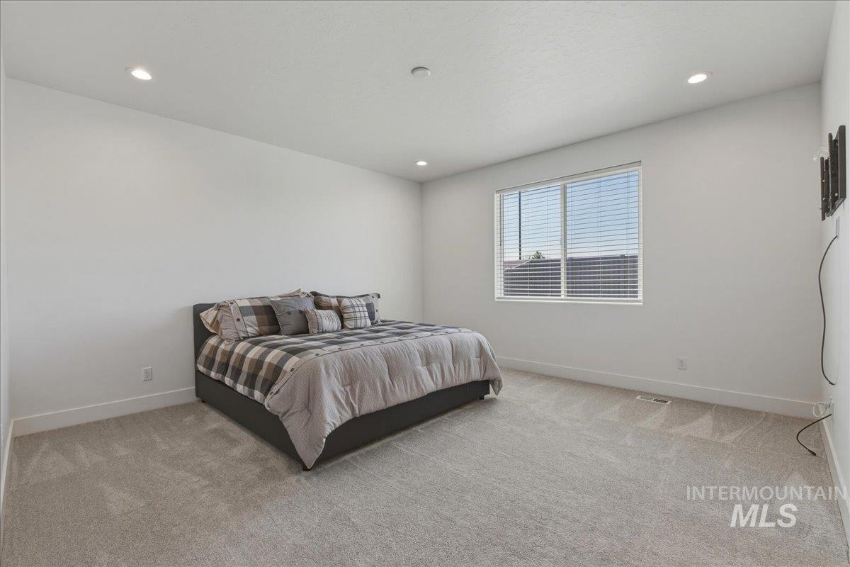 2109 North Gelding Court Middleton, ID 83644 - Photo 19 of 39 Bedroom featuring light colored carpet and recessed lighting
