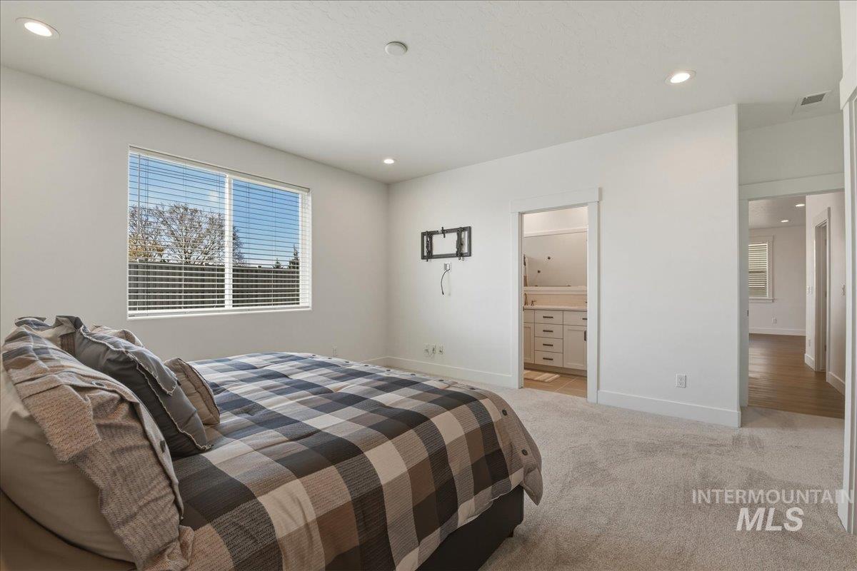 2109 North Gelding Court Middleton, ID 83644 - Photo 21 of 39 Bedroom with light carpet and recessed lighting