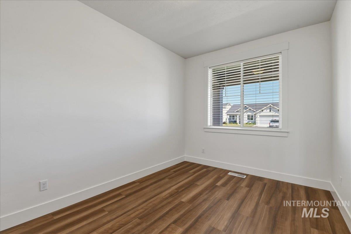 2109 North Gelding Court Middleton, ID 83644 - Photo 25 of 39 Unfurnished room with baseboards and dark wood finished floors