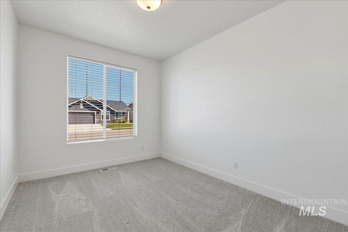 2109 North Gelding Court Middleton, ID 83644 - Photo 27 of 39 Empty room featuring light colored carpet and baseboards