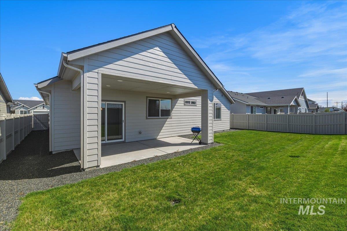 2109 North Gelding Court Middleton, ID 83644 - Photo 35 of 39 Back of house with a patio area and a fenced backyard