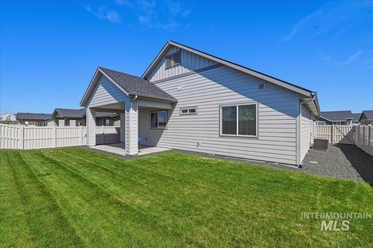 2109 North Gelding Court Middleton, ID 83644 - Photo 37 of 39 Rear view of property featuring a patio, a fenced backyard, and board and batten siding