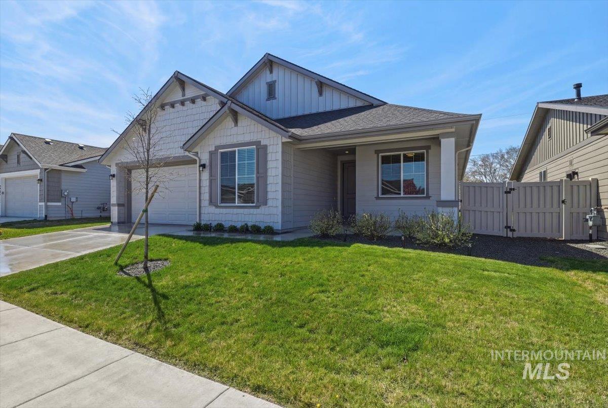2109 North Gelding Court Middleton, ID 83644 - Photo 4 of 39 View of front of house with a gate, board and batten siding, a front yard, concrete driveway, and roof with shingles