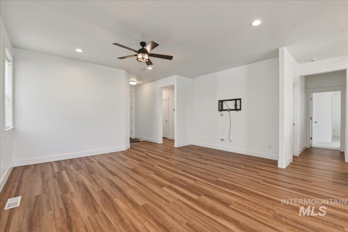 2109 North Gelding Court Middleton, ID 83644 - Photo 10 of 39 Unfurnished living room with ceiling fan, light wood-style floors, and recessed lighting