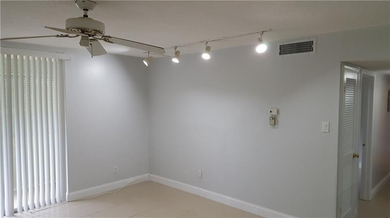 22785 Southwest 66th Avenue, Unit 103 Boca Raton, FL 33428 - Photo 6 of 8 a view of a room with a hanging light and kitchen view