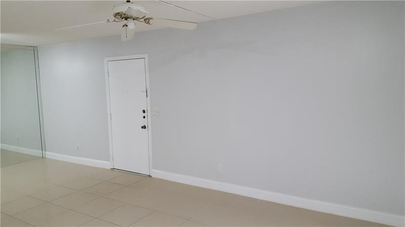 22785 Southwest 66th Avenue, Unit 103 Boca Raton, FL 33428 - Photo 7 of 8 an empty room with a chandelier fan