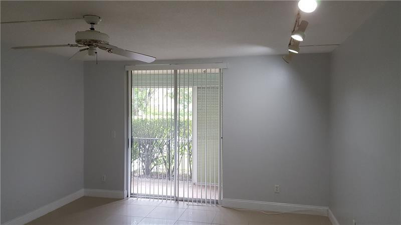 22785 Southwest 66th Avenue, Unit 103 Boca Raton, FL 33428 - Photo 8 of 8 wooden floor in an empty room with a window