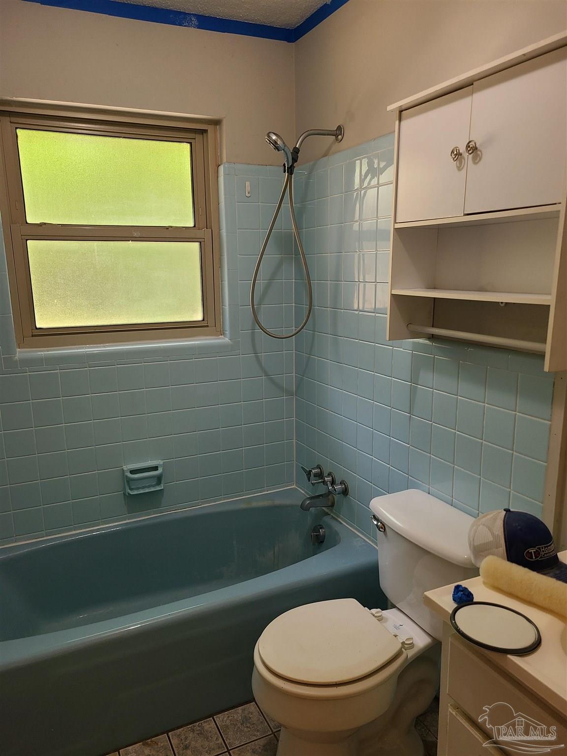 7758 Kipling Street Pensacola, FL 32514 - Photo 11 of 23 a bathroom with a toilet a sink and a shower