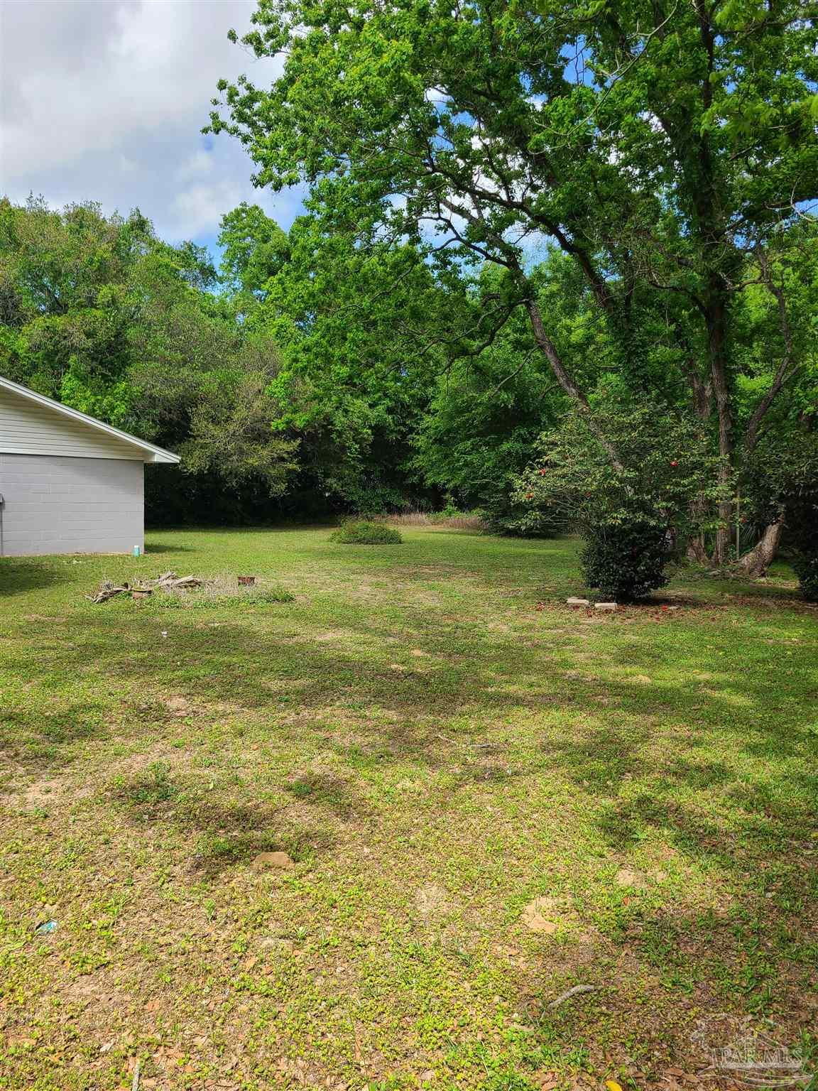 7758 Kipling Street Pensacola, FL 32514 - Photo 19 of 23 a view of a field with an trees