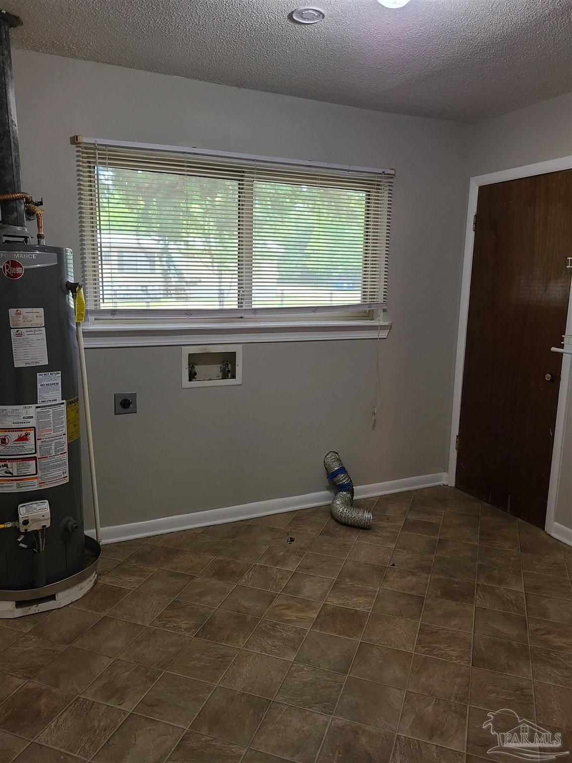 7758 Kipling Street Pensacola, FL 32514 - Photo 7 of 23 a view of a room with gym equipment and a window