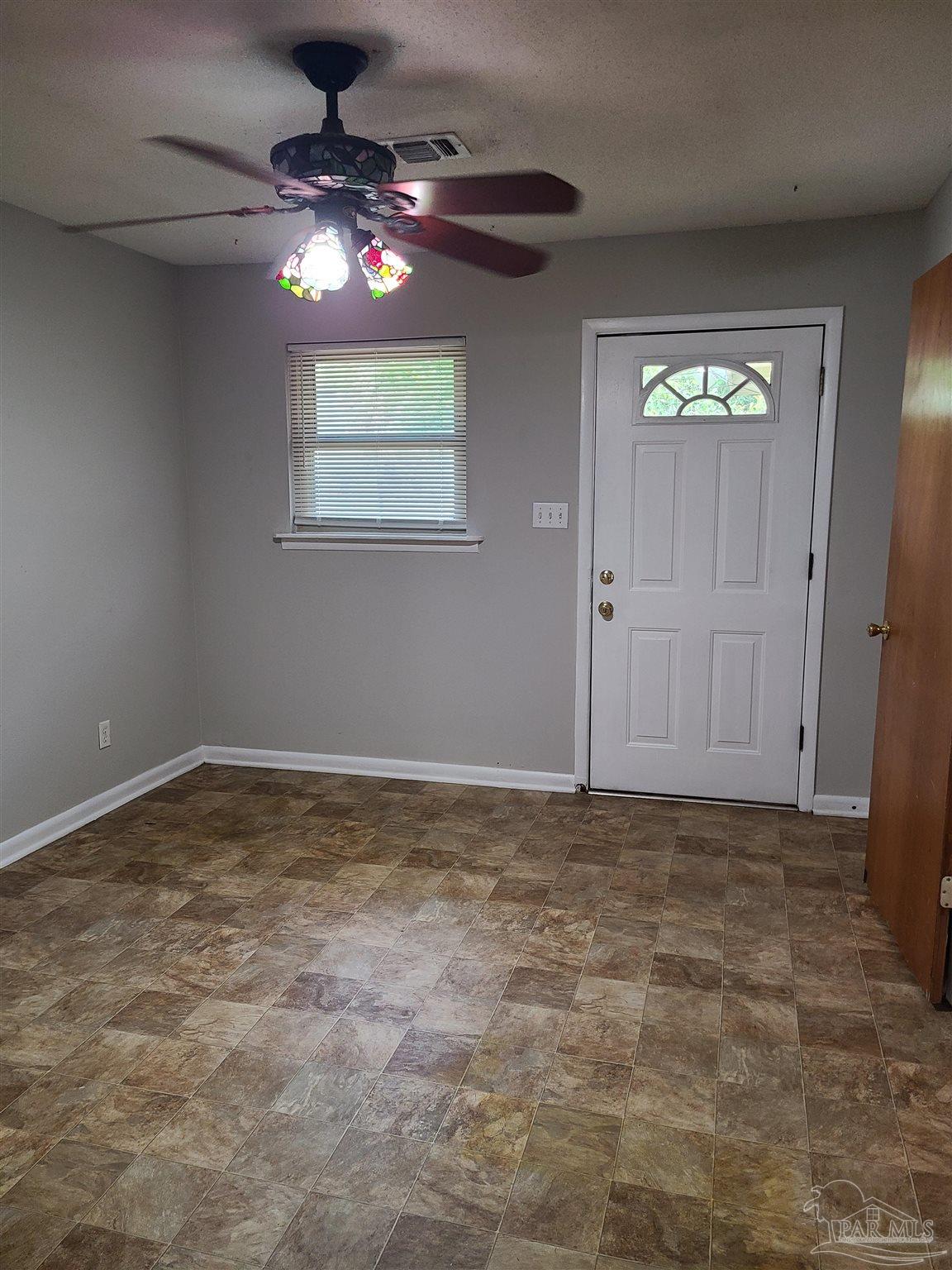 7758 Kipling Street Pensacola, FL 32514 - Photo 8 of 23 a view of an empty room with a chandelier fan