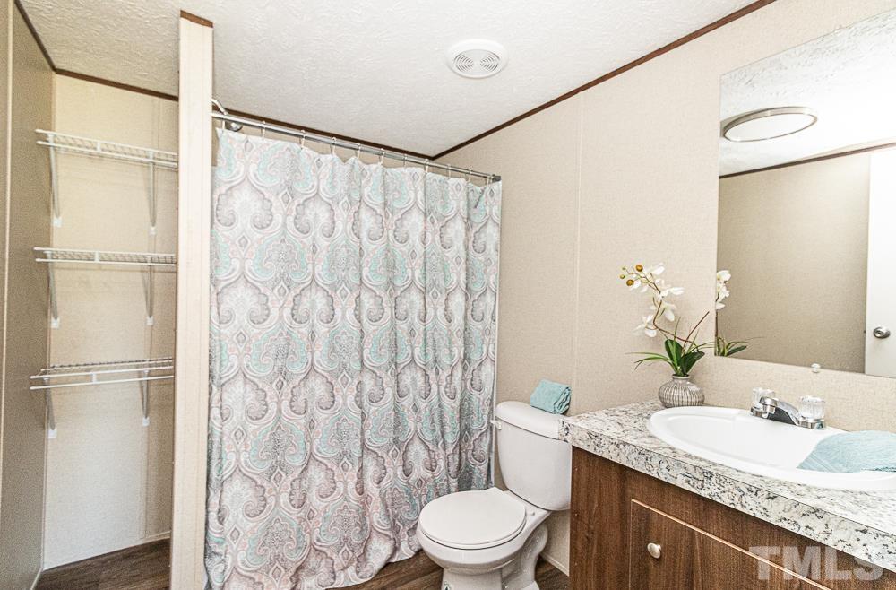 7252 Broad Leaf Dr Spring Spring Hope, NC 27882 - Photo 14 of 17 a bathroom with a granite countertop sink toilet and shower