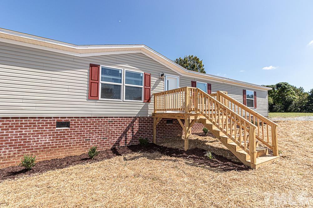 7252 Broad Leaf Dr Spring Spring Hope, NC 27882 - Photo 15 of 17 a view of wooden house with large windows