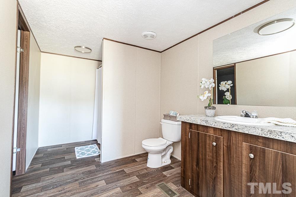 7252 Broad Leaf Dr Spring Spring Hope, NC 27882 - Photo 10 of 17 a bathroom with a granite countertop sink toilet and shower