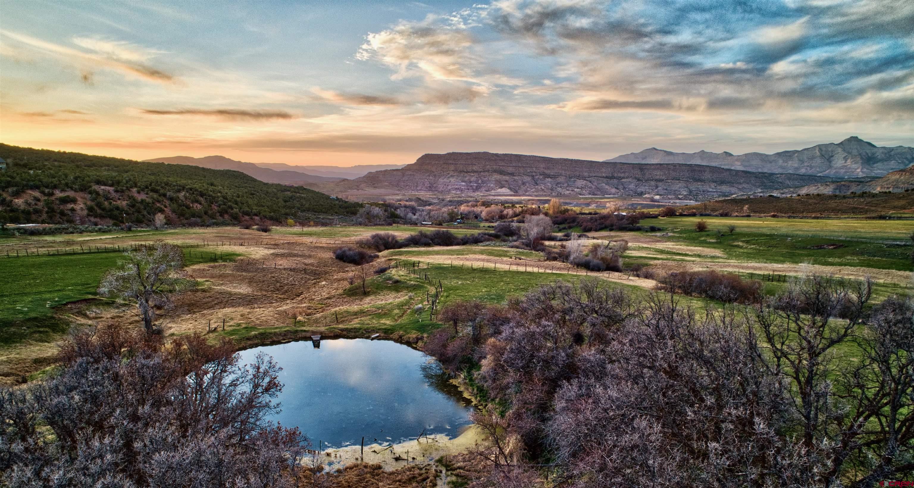 51804 KE Road Mesa, CO 81643 - Photo 15 of 29 a view of a lake with mountains in the background