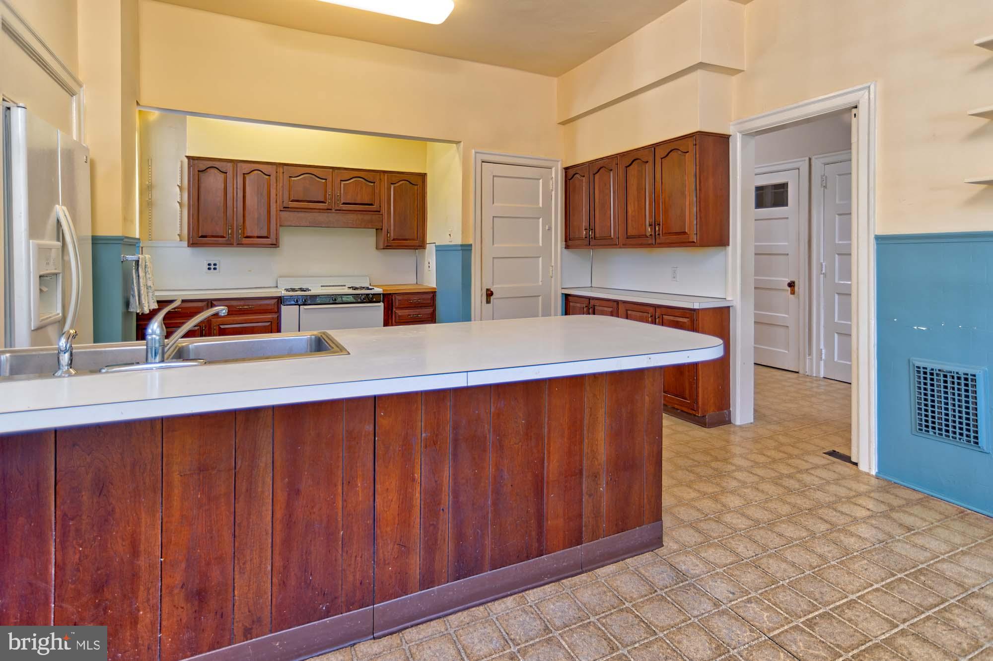 132 St Georges Road Ardmore, PA 19003 - Photo 27 of 87 a kitchen with stainless steel appliances a sink cabinets and wooden floor
