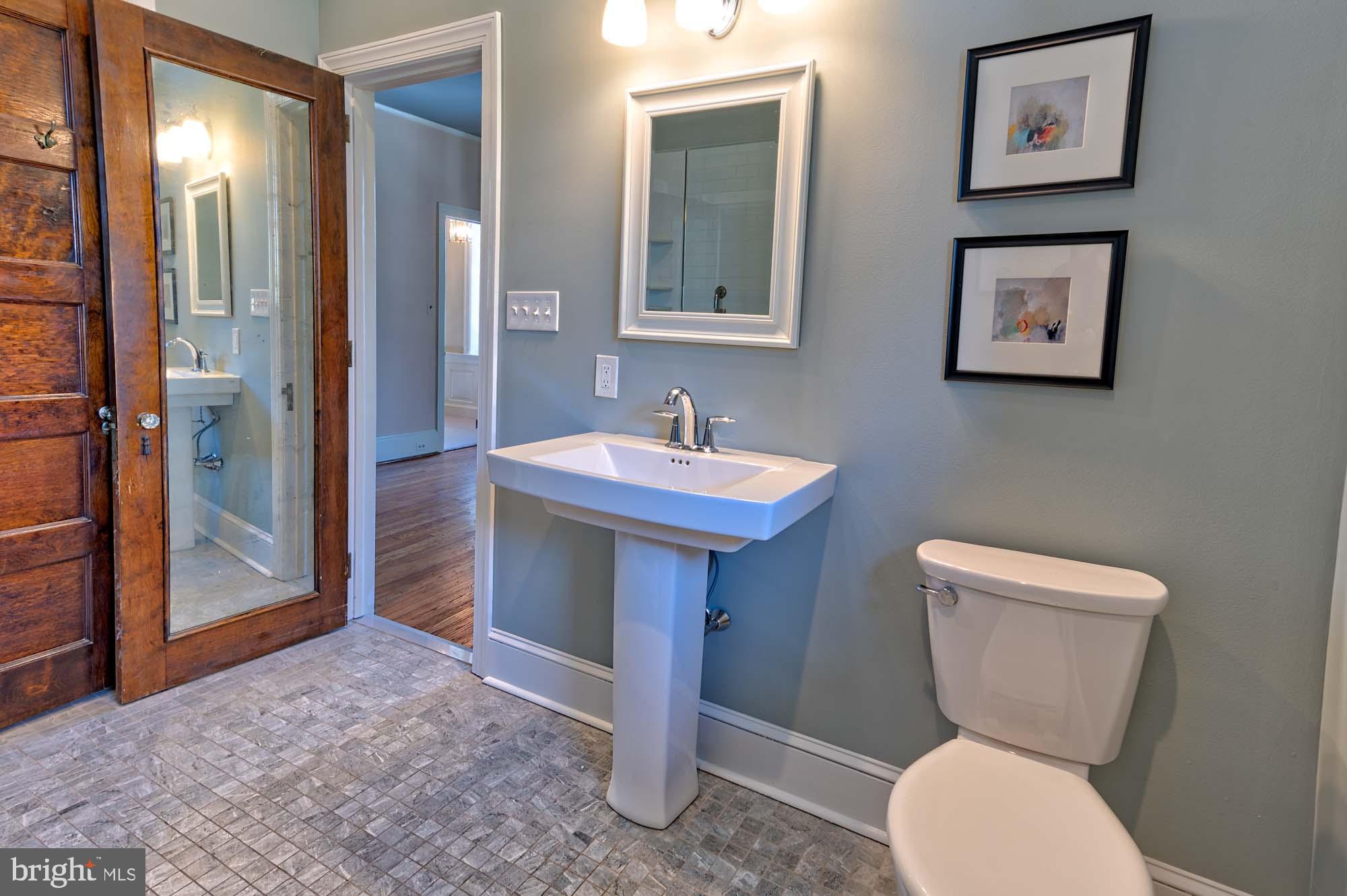 132 St Georges Road Ardmore, PA 19003 - Photo 39 of 87 a bathroom with a toilet sink and mirror