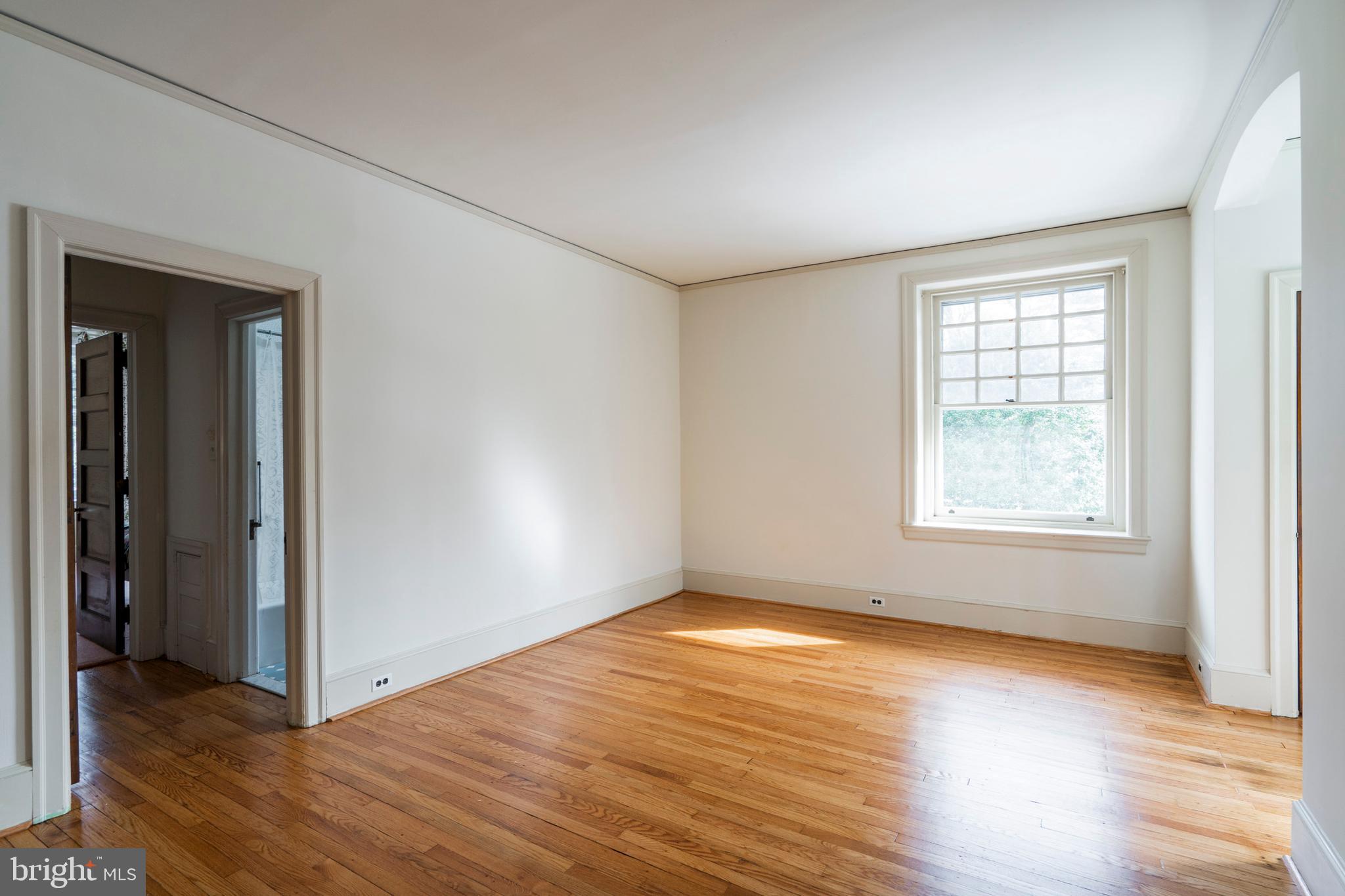 132 St Georges Road Ardmore, PA 19003 - Photo 43 of 87 a view of an empty room with wooden floor and a window