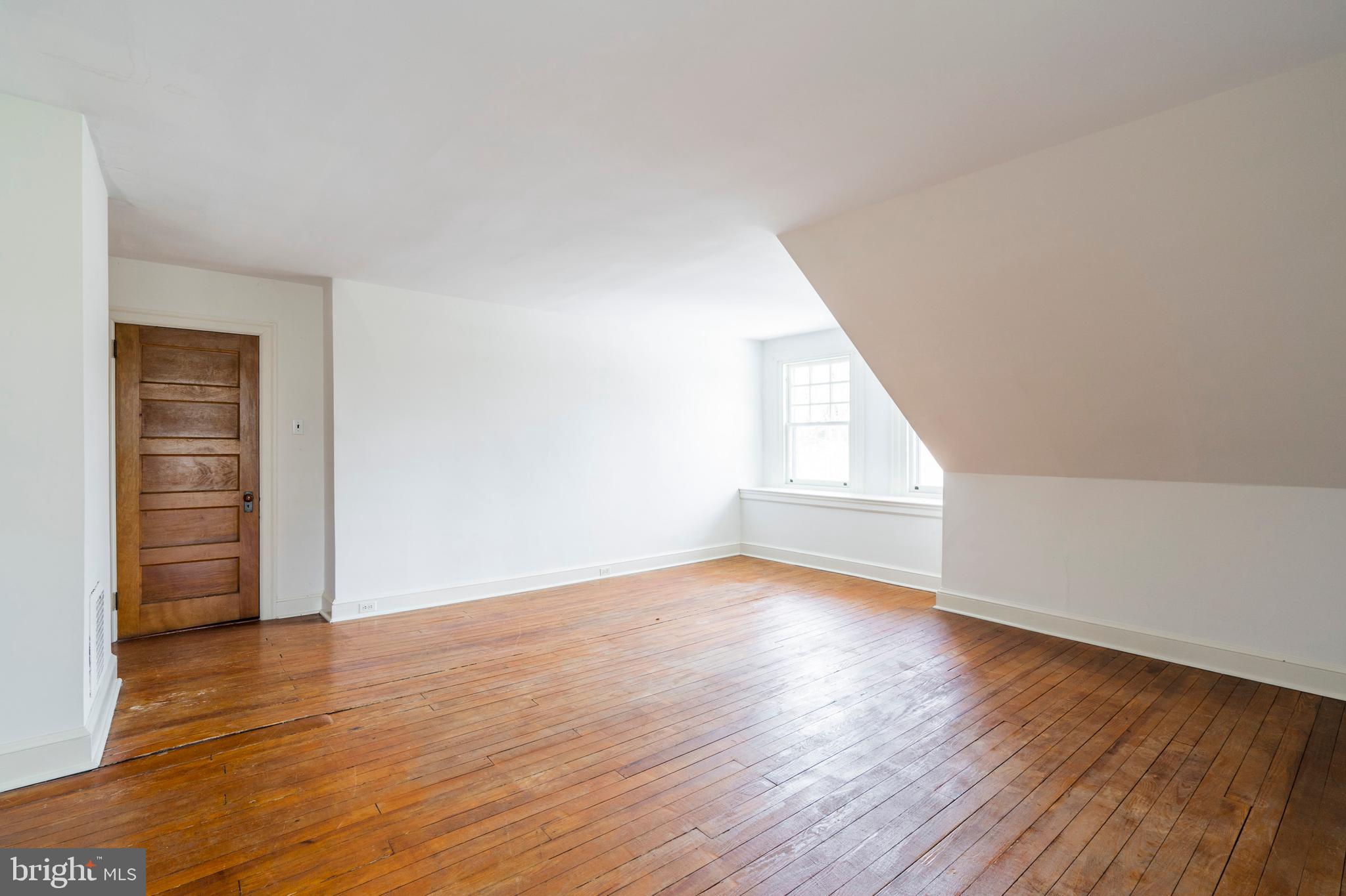 132 St Georges Road Ardmore, PA 19003 - Photo 64 of 87 a view of an empty room with wooden floor and window