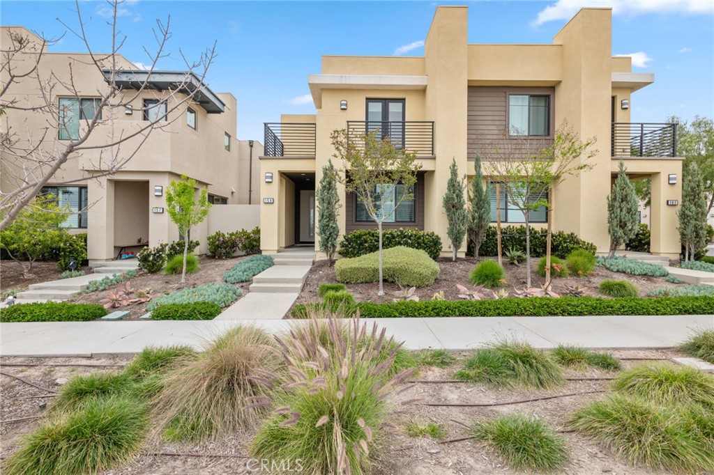 a view of a building with a garden and pathway