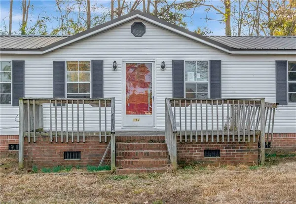 a front view of a house with a fence