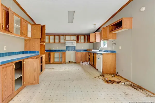 a view of a kitchen with a sink and cabinets