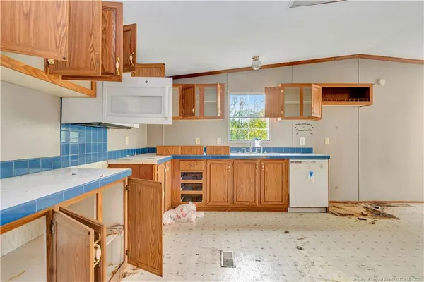 a view of a kitchen with a sink and cabinets