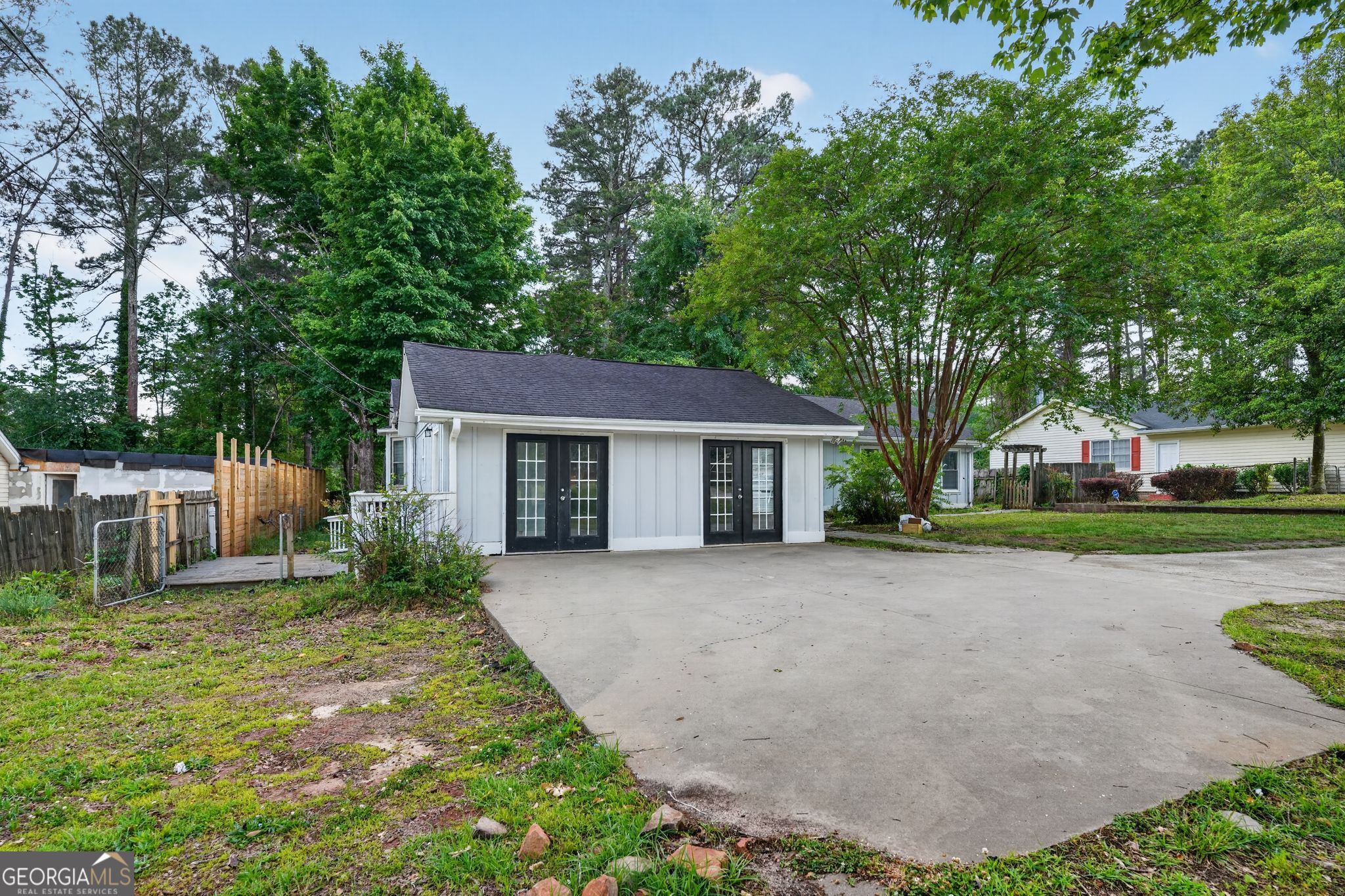 3285 Old Salem Road Southeast Conyers, GA 30013 - Photo 5 of 33 a front view of a house with a garden and trees