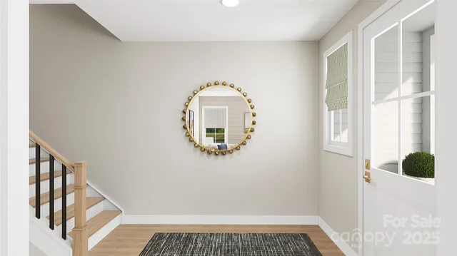 a view of a livingroom with wooden floor and white walls