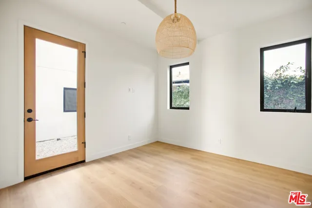 a view of a room with wooden floor and a bathroom