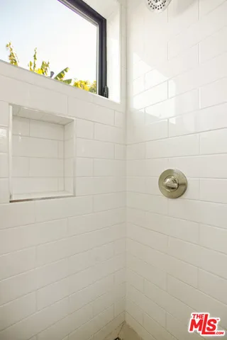 a bathroom with a toilet a sink and a window