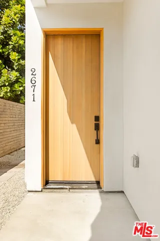 a view of a hallway to a livingroom with furniture and stairs